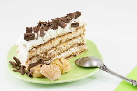 Chestnut cake slice on a green plate served with whole cooked chestnuts