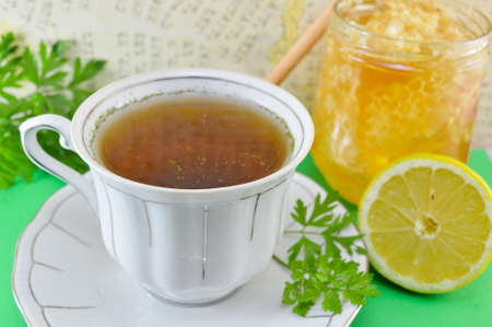 Hot tea with parsley, lemon and honey in a jarの写真素材