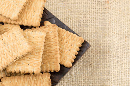 Bunch of sweet cookies in a bowl on a rustic tableclothの写真素材