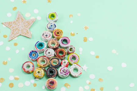 Christmas tree made out of paper with cut out star shapesの写真素材