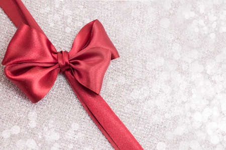 Red Christmas bow for presents on sparkling backgroundの写真素材
