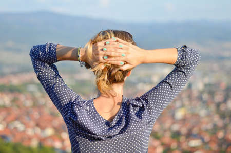Girl facing a nice cityview from mountain viewpointの写真素材