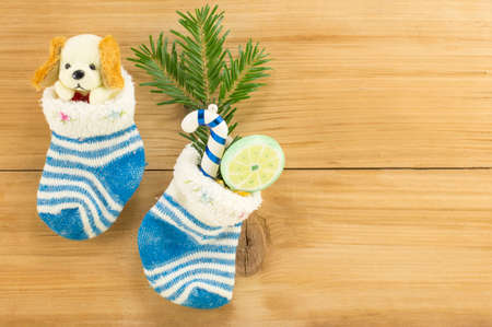 Christmas presents in socks and fir tree decoration