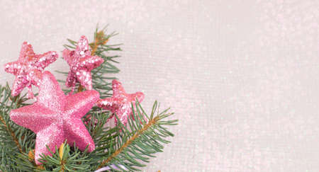 Pink star sjhaped Christmas decoration and fir treeの写真素材