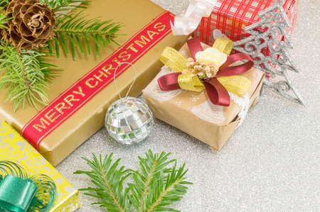 Various Christmas decorations on shiny silver background