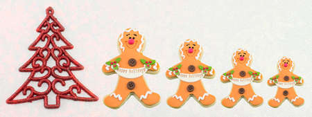 Christmas tree decoration with gingerbread cookies on shiny background