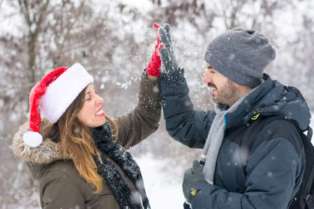 Couple in love having fun outdoors on a snowy winter dayの写真素材