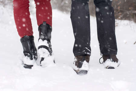 Couple in love outdoors walking on snowy winter dayの写真素材
