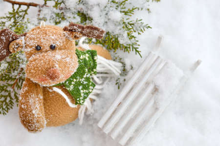 Snow covered reindeer toy with sledgesの写真素材