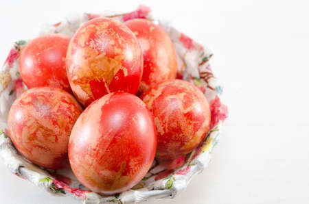 Hand painted decoupage Easter eggs in a decorated bowl