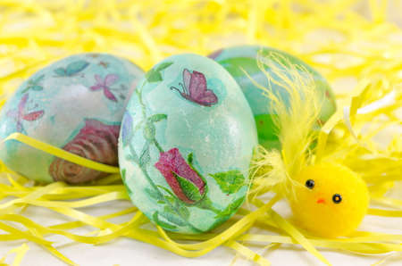 Hand painted decoupage Easter eggs in hay like straws