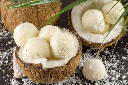 Fresh coconut and coconut cookies on dark wooden backgroundの写真素材