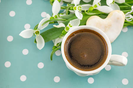 Cup of coffee with fresh snowdrops