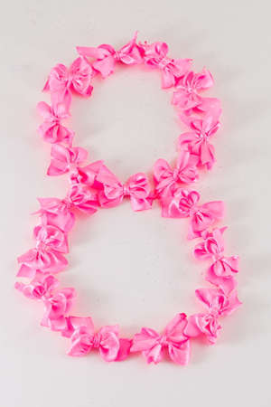 Figure of 8 made of small pink ribbonsの写真素材