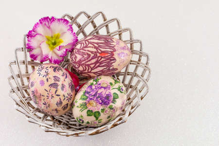Colorful painted and decorated Easter eggs in a basketの写真素材