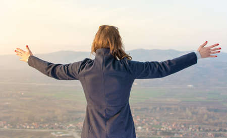 Girl on hiking trip enjoying the view from above