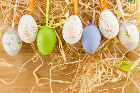 Easter eggs hanging from the colorful ropesの写真素材
