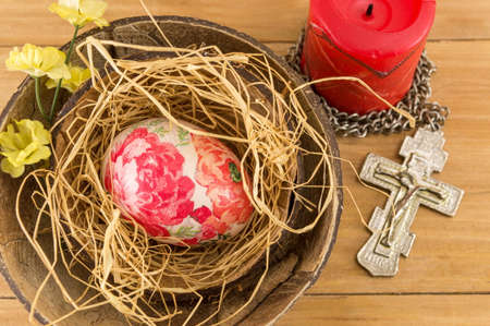 Decorated Easter eggs in a coconut shell as a bowlの写真素材