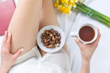 Woman working on a notebook while in bed