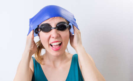 Happy girl with a swimming hat ready for the summerの写真素材