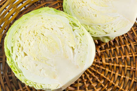 Halved cabbage in a wicker basket close up