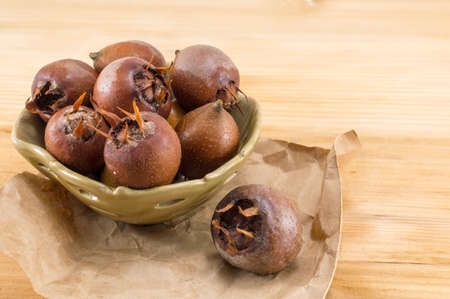 Healthy ripe Medlars on an old wooden tableの写真素材