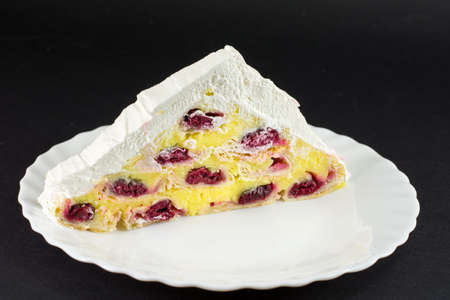 triangle cherry cake on black background