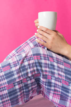 Woman in pijama having a morning cup of coffeeの写真素材