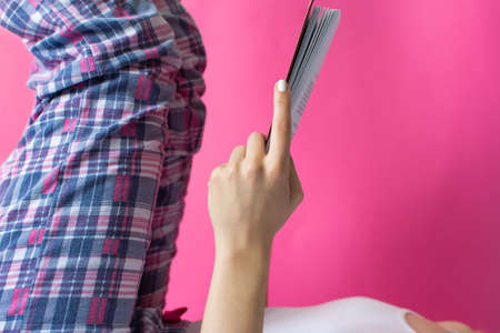 Pose for reading a book in bed. Woman reading in bedの写真素材