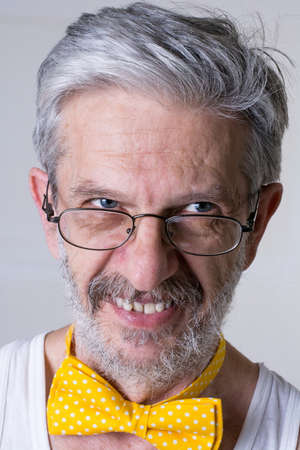 Funny senior man with a bow tie arround his neck