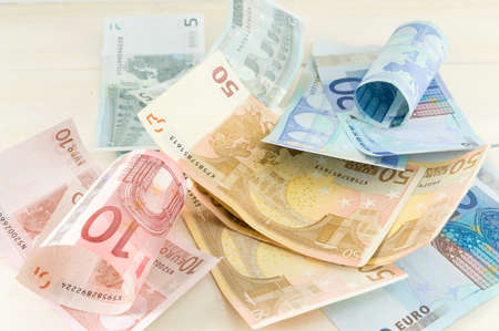 Bunch of euro bills on a wooden table