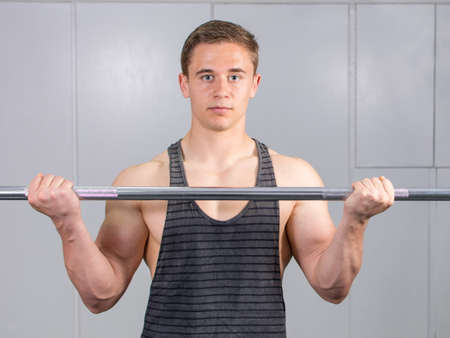 Man warming up his biceps at the gymの写真素材