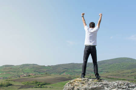 Male hiker enjoying the view from aboveの写真素材