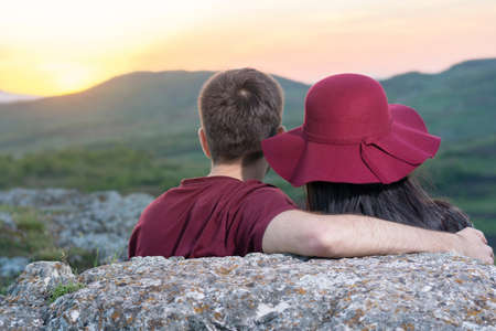 Couple enjoying a romantic sunset on a hiking tripの写真素材