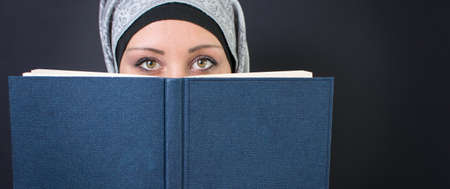 Young muslim woman holding a bookの写真素材