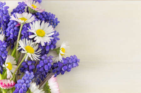 Chamomile and hyacinth flowers on a wooden tableの写真素材