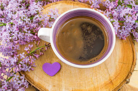 Cup of coffee and purple spring flowersの写真素材