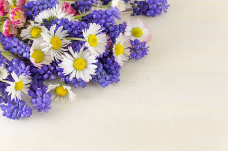 Chamomile and hyacinth flowers on a wooden tableの写真素材