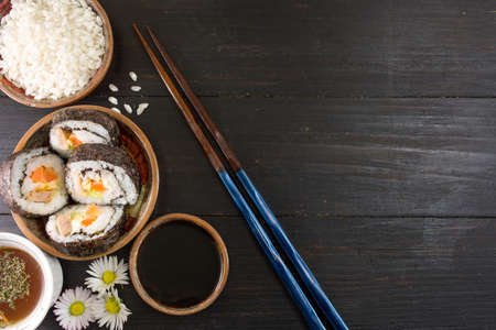 Sushi rolls and chopsticks with sushi ingredientsの写真素材