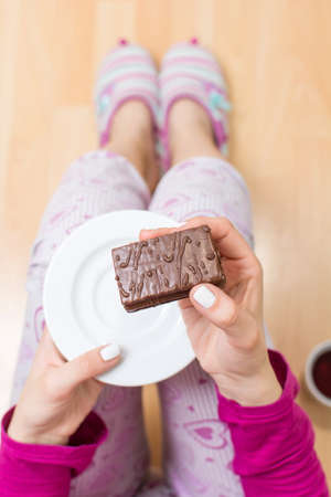 Woman eating biscuit first person view