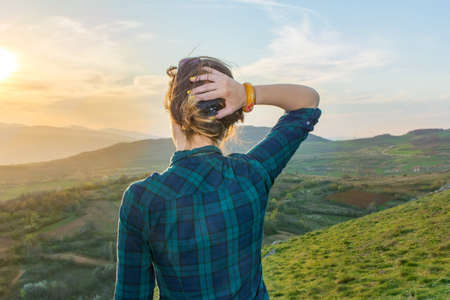 Girl on hiking trip enjoying the sunset view from aboveの写真素材