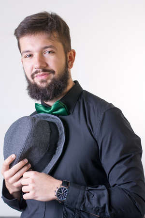 Fashionable man in a black shirt with a bow tieの写真素材