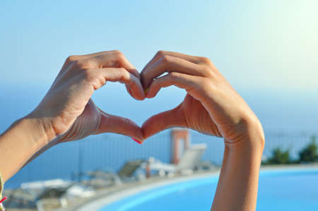 Love for summer vacation. Hands making heart shapeの写真素材