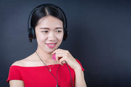 Beautiful asian woman listening to music with headphonesの写真素材