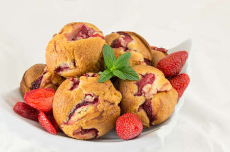 Strawberry muffins on a plate with fresh strawberry fruitの写真素材