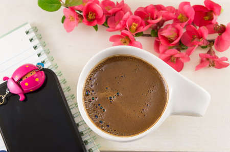 Japanese rose flowers and a cup of coffeeの写真素材