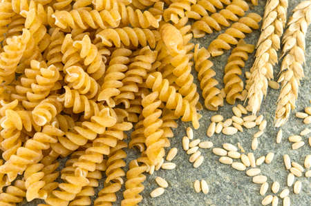 Bunch of golden colored macaroni pasta on a table