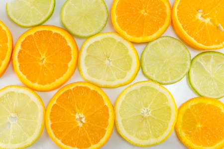 Lime fruit and orange slices making background patternの写真素材