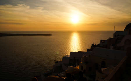Romantic seaside sunset with Santorini island silhouette in Greeceの写真素材