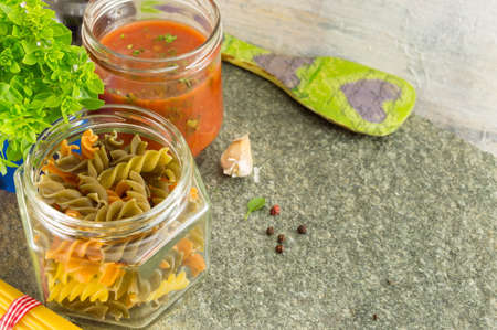 Pasta making ingredients in bowls on a stone tableの写真素材